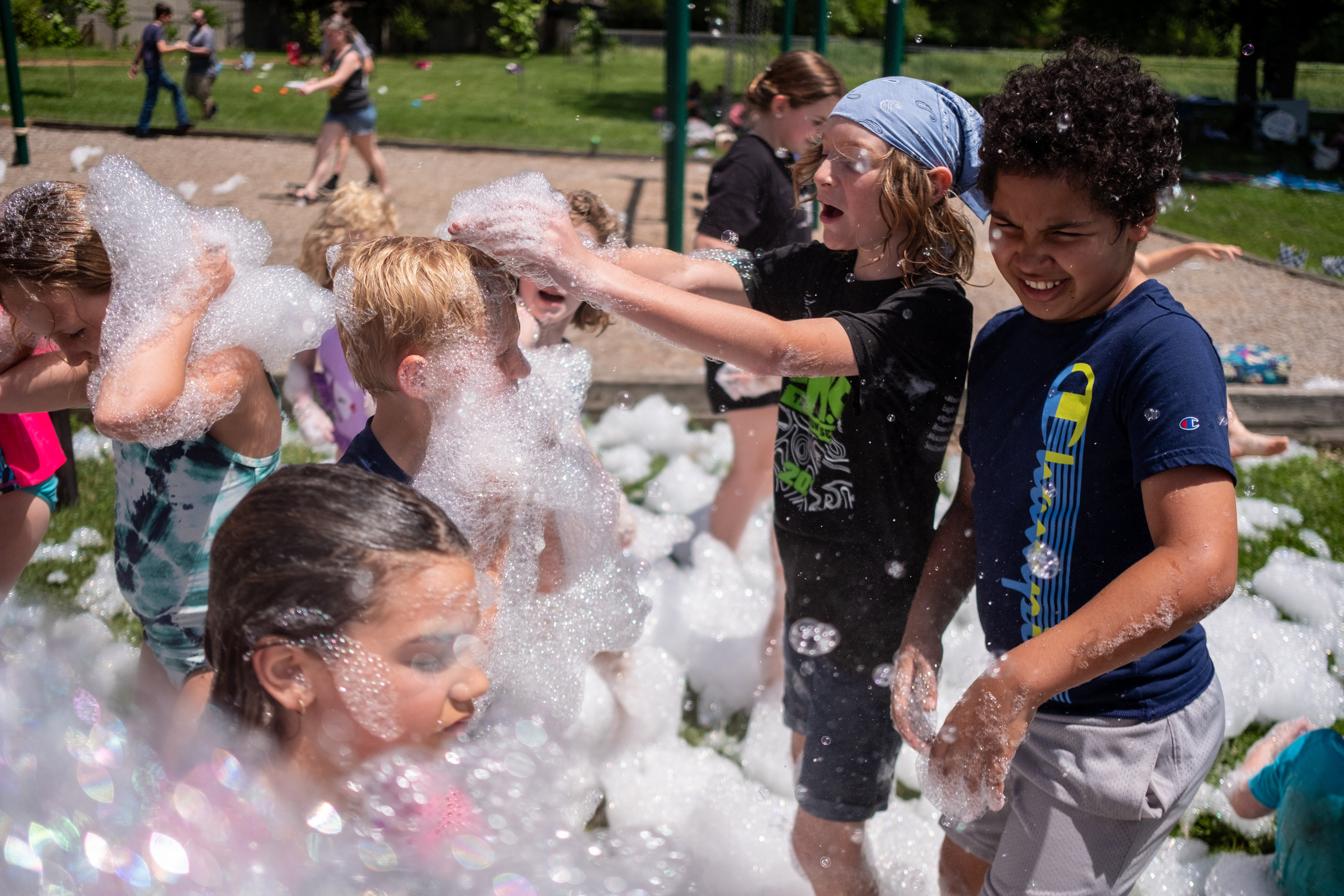 Kids playing in foam and bubbles at Field Day